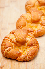 Image showing fresh baked french croissant brioche on wood board