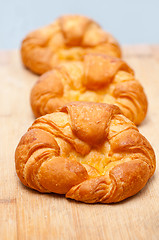 Image showing fresh baked french croissant brioche on wood board