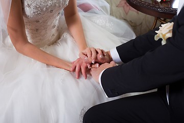 Image showing gentle hands of the groom and bride