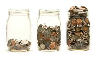 Image showing Three glass jars holding coins