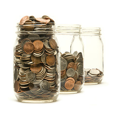 Image showing Three glass jars filled with American coins