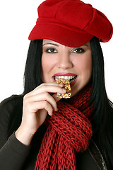 Image showing Female eating healthy nut bar