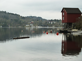 Image showing small building on stilts on coastline in norway