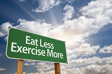 Image showing Eat Less Exercise More Green Road Sign and Clouds