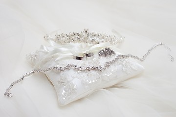 Image showing personal accessories of bride on white pillow