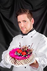 Image showing Handsome confectioner with cake 