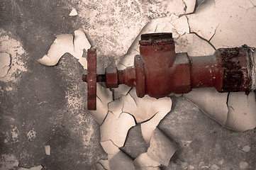 Image showing Rusty old tap against concrete wall