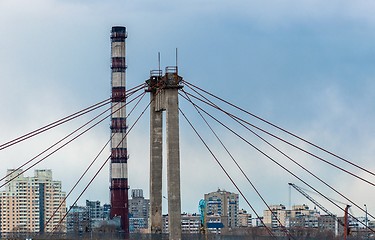 Image showing Big industrial chimney in the middle of a city