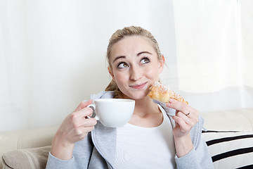 Image showing beautiful woman relaxing on couch with cup of coffe 