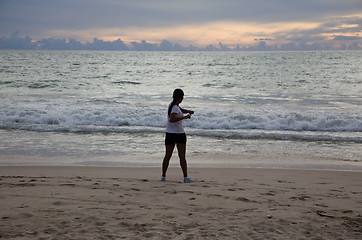 Image showing Thai girl doing gymnastics on the beach