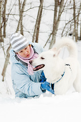 Image showing The woman with a dog in winter on walk