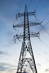 Image showing Silhouette of a pillar of electricity transmissions on a backgro