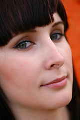 Image showing girl is posing against orange wall