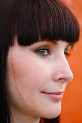 Image showing girl is posing against orange wall