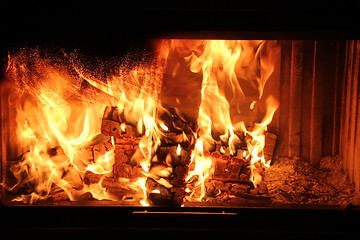 Image showing burning wood in a fireplace