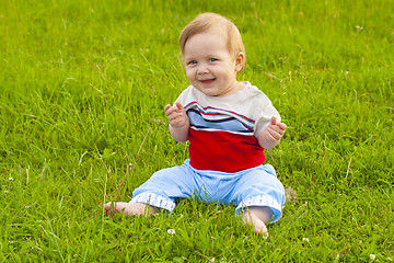 Image showing baby sitting on grass