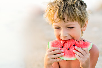 Image showing boy taking a bite of watermelon