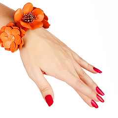 Image showing red manicure and orange bracelet