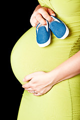 Image showing pregnant woman with baby shoes