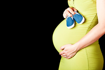 Image showing pregnant woman with baby shoes