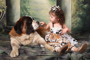 Image showing Adorable Child and Her Saint Bernard Puppy Dog