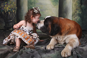 Image showing Adorable Child and Her Saint Bernard Puppy Dog