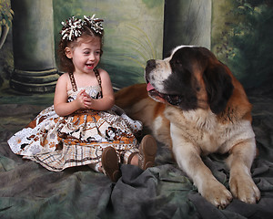 Image showing Adorable Child and Her Saint Bernard Puppy Dog