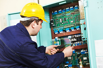 Image showing Electrician checking current at power line box