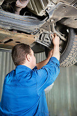 Image showing auto mechanic at car suspension repair work