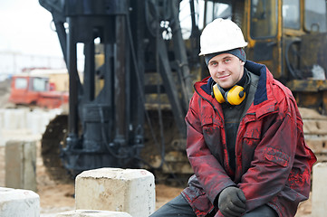 Image showing builder in dirty workwear at construction site