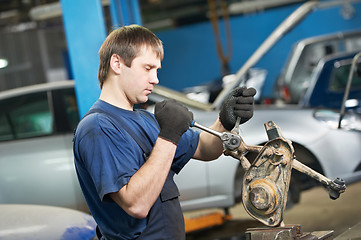 Image showing auto mechanic at work with wrench spanner
