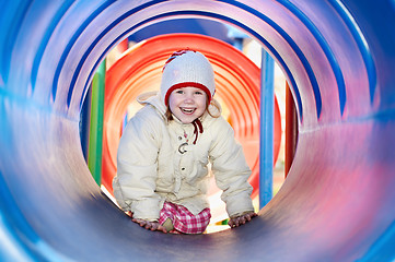 Image showing laughing little baby girl in tube