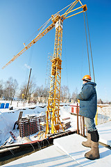 Image showing worker with tower crane remote control equipment