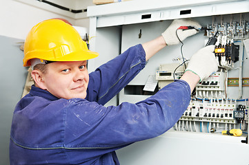 Image showing Electrician measure voltage with multimeter