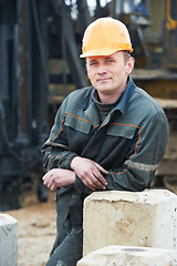 Image showing builder in dirty workwear at construction site