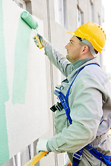 Image showing builder facade painter at work