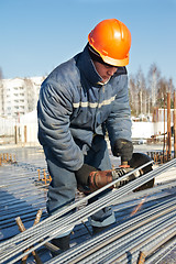 Image showing builder works with concrete reinforcement