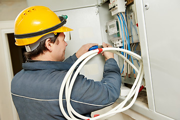 Image showing Electrician installing energy saving meter