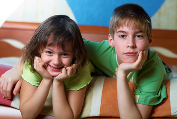 Image showing Children lying on their bellies in a bedroom