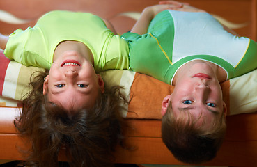 Image showing Two smiling kids lying in bed