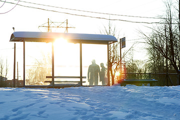 Image showing public transport stop with people silhouette