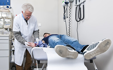 Image showing Doctor examining wound