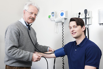 Image showing Doctor Reading Pulse Rate Of a Patient