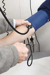 Image showing Checking Blood Pressure Of a Patient