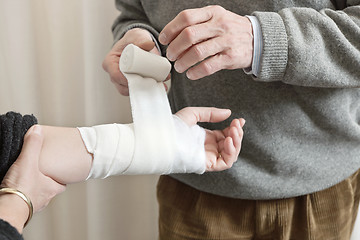 Image showing Doctor Applying Bandage On Injured Hand
