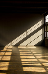 Image showing Late day window light streaming thru windows into vacant loft