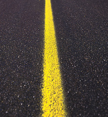 Image showing Asphalt road texture with yellow stripe