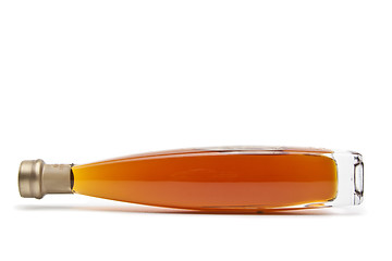 Image showing Alcohol cognac in a closed bottle on white background