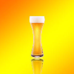 Image showing Beer glass with froth over yellow background