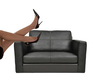 Image showing Woman with beautiful legs sitting on sofa